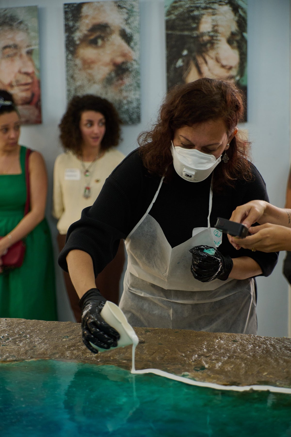 A participant pours the resin